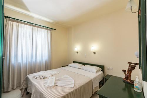 a hotel room with two beds and a window at Gianna Apartments in Almirida
