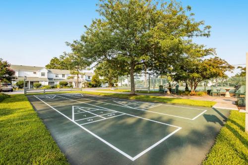 a basketball court in a yard with a tree at Mallard Lakes - 142 Cardinal in Selbyville