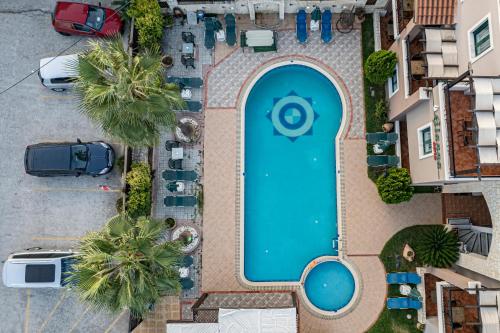 an overhead view of a swimming pool in a parking lot at Gianna Apartments in Almirida