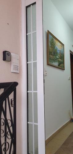 a glass door in a room with a picture on the wall at panos rooms in Kalabaka