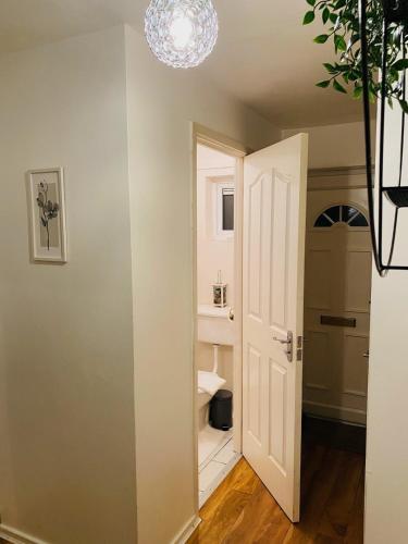 a hallway with a bathroom with a toilet in it at Cheerful home near City Centre,Station& RaceCourse in Doncaster