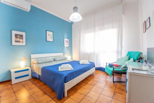 a blue bedroom with a bed and a chair at B&B DREAM in Francavilla al Mare