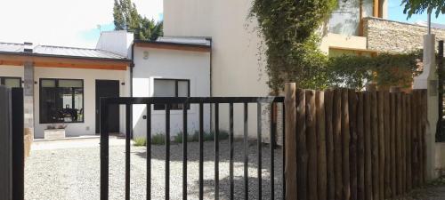 a black fence in front of a house at Duplex Patagonia in Esquel