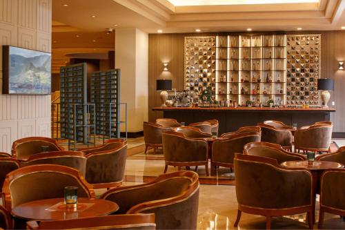 a restaurant with chairs and a bar with wine bottles at Sheraton Lima Historic Center in Lima
