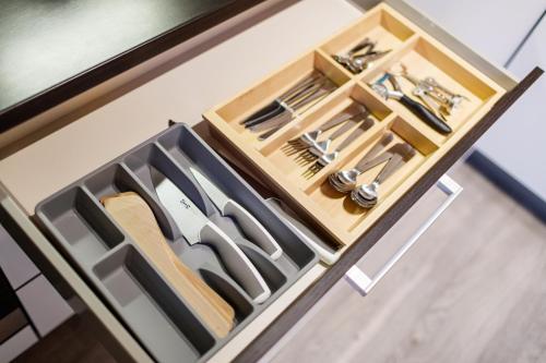 a drawer with knives and utensils in it at Golden Apartments Rezidence Nová Karolina II. in Ostrava