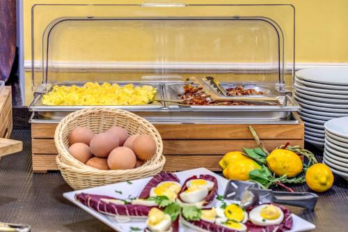 a buffet with eggs and other food on a table at Hotel Ottaviano Augusto in Rome