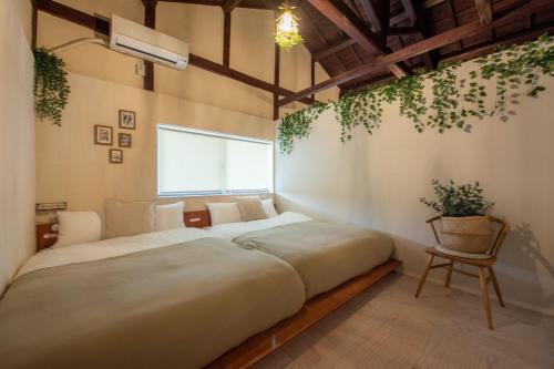 een slaapkamer met een groot bed en een stoel bij KOU Namba-Kuromon - Vacation STAY 9236 in Osaka