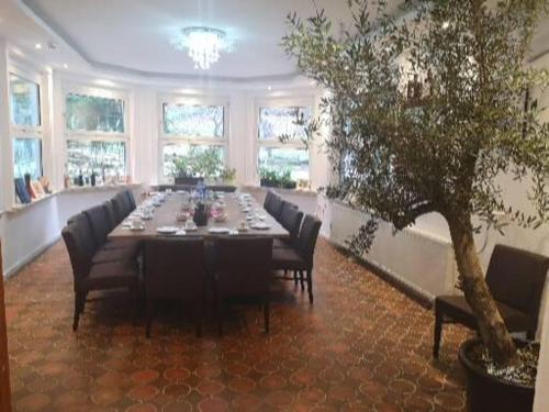 a large dining room with a long table and chairs at Hotel Radevormwald in Radevormwald