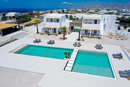 a large swimming pool with a large building at Adama Mykonos Boutique Hotel in Mikonos