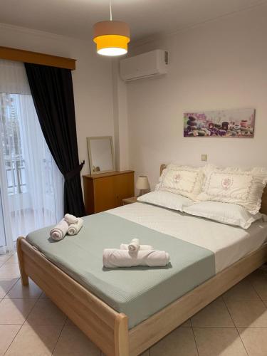 a bedroom with a large bed with towels on it at The Gemini Suites in Kos Town