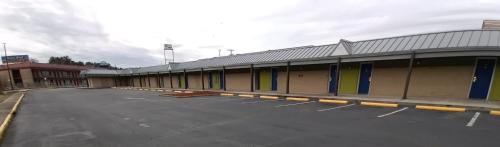 an empty parking lot in front of a building at Travelodge by Wyndham Petersburg in Petersburg