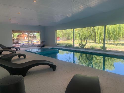 una grande piscina in un soggiorno con finestre di Cabañas "Las Escondidas" a Valle Grande