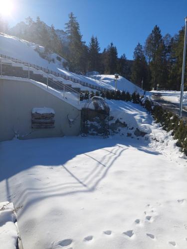 a snow covered train station with a train on it at Appartement Naturnah in Mieders