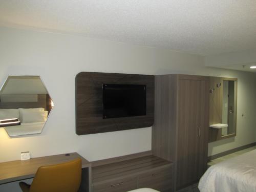 a hotel room with a bed and a desk with a television at Holiday Inn Express & Suites Donegal by IHG in Donegal