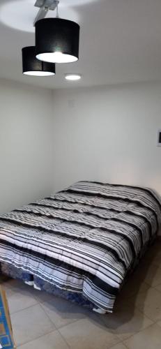 Un pat sau paturi într-o cameră la CAUQUEN BARILOCHE