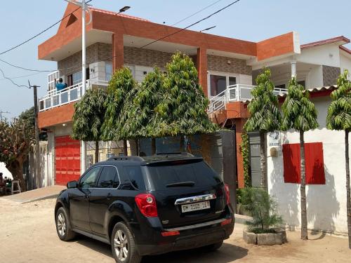 a black suv parked in front of a house at Holiday Appartment Elbe in Lomé