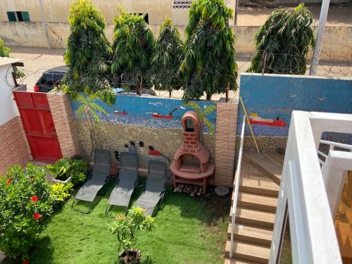 a view of a yard with chairs and a table at Holiday Appartment Elbe in Lomé