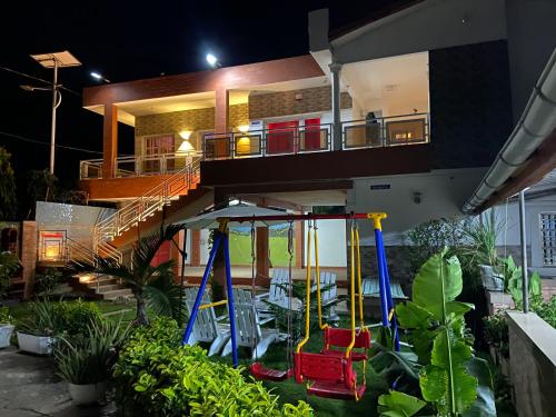 a house with a porch with chairs and a swing at Holiday Appartment Elbe in Lomé