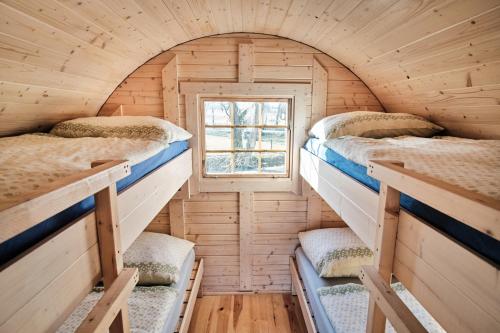 a small room with four bunk beds in it at Viking houses Strnadovský Mlýn in Jesenice