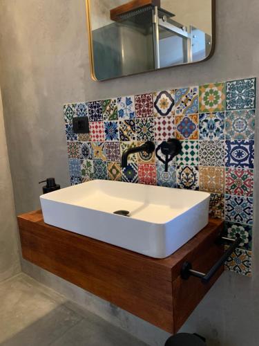 a bathroom with a white sink and a mirror at Il Giardino Segreto Gardasee Ferienhaus in Manerba del Garda