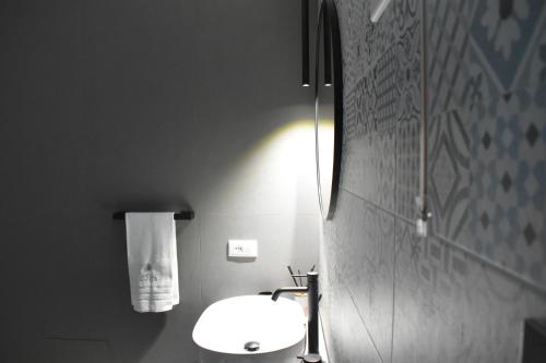 a bathroom with a white toilet and a sink at White Wall luxury rooms Scala dei turchi in Realmonte