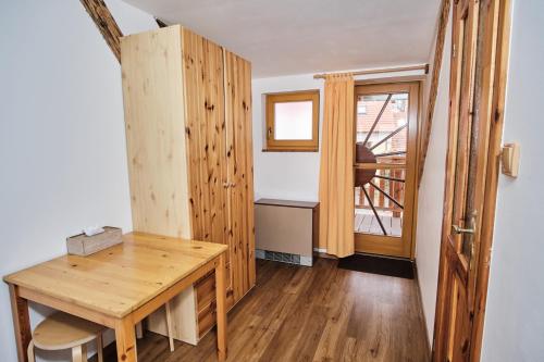 a room with a wooden table and a window at Strnadovský mlýn in Jesenice