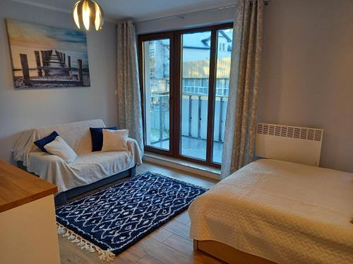 Ένα ή περισσότερα κρεβάτια σε δωμάτιο στο Apartament Ami Stegna