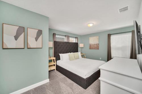 Un dormitorio con una cama y dos ventanas. en 4200 Paragraph Drive, en Kissimmee