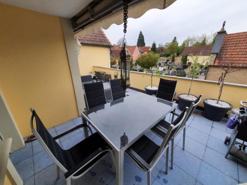 a table and chairs on a balcony with a view at Unterkunft Mitten im schönen Frankenland in Buchbrunn
