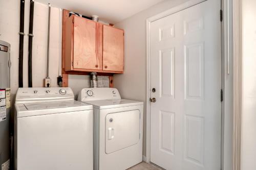 a white laundry room with a washer and dryer at Coram's Corner in Jacksonville Beach