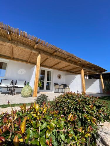 a porch of a house with a wooden roof at B&B Anastasia in Santa Teresa Gallura