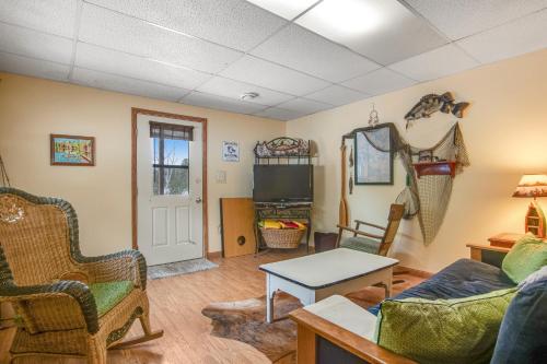 a living room with a couch and a table at RTLCMP Lakehouse in Arbor Vitae