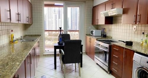una cocina con armarios morados y una mesa con sillas. en Backpackers zone en Dubái