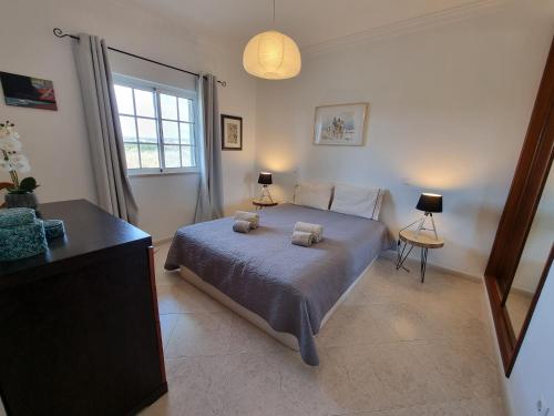 a bedroom with a bed with two towels on it at Apartamento Praia Altura by Homekeys in Altura