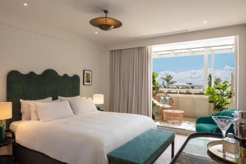 a bedroom with a large bed and a large window at InterContinental Sorrento Mornington Peninsula in Sorrento