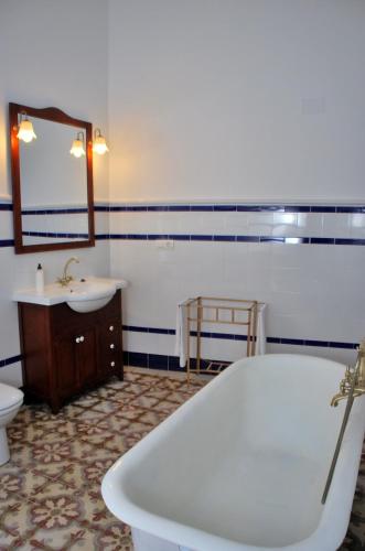 a bathroom with a tub and a toilet and a sink at La Casona De Tia Victoria in Rueda