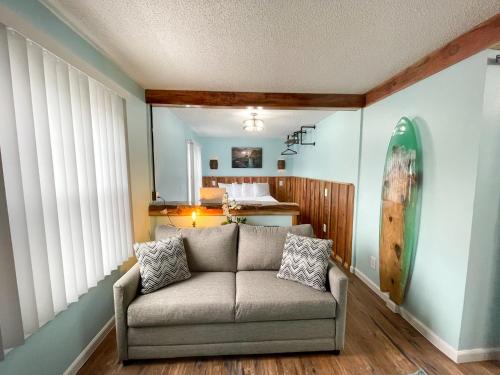 a living room with a couch in a room at The Anchorage Motel in Pacific City