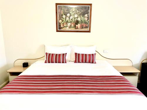 a bed with a white bedspread and pillows at Golfview Motor Inn in Wagga Wagga