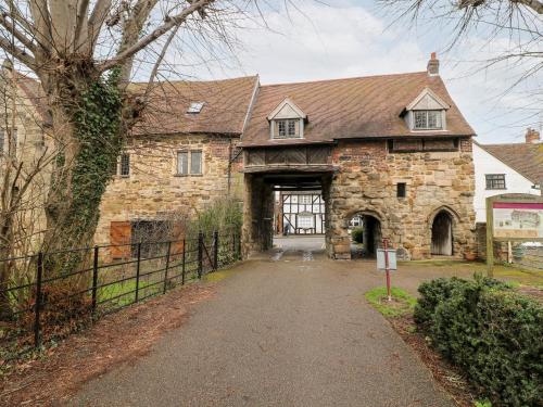 a large stone house with a large door at Porter's Lodge in Tamworth