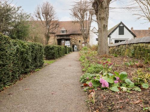 a path in front of a house with flowers at Porter's Lodge in Tamworth