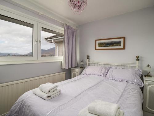 ein Schlafzimmer mit einem Bett mit Handtüchern darauf in der Unterkunft Manesty View in Keswick