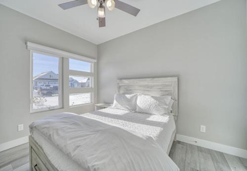 a white bedroom with a bed and a ceiling fan at Twin Falls Modern Retreat in Twin Falls