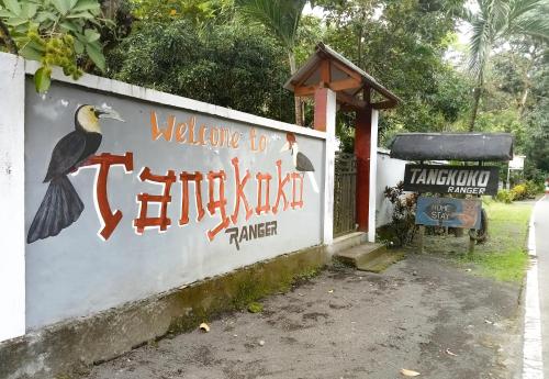 a sign for a bird park with two birds on it at Tangkoko Ranger Homestay in Bitung