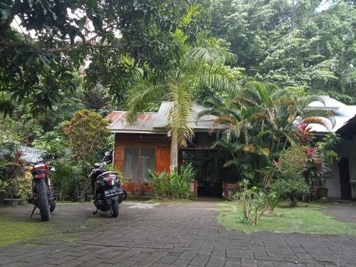 two motorcycles parked in front of a house at Tangkoko Ranger Homestay in Bitung