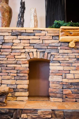 an outdoor fireplace made out of a stone wall at Inn at the Canyons in Monticello