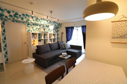 a living room with a couch and a table at Hassamu 3 Jo 1-11-1 Corole Kotoni - Vacation STAY 11468 in Sapporo