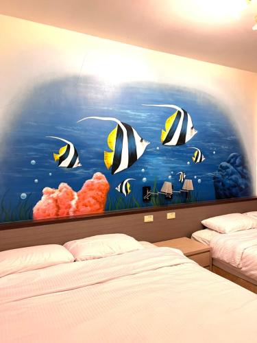 a bedroom with a painting on the wall at Sea Travel in Xiaoliuqiu