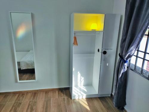 a room with a mirror and a room with a bed at Semi-Detached, Up to 21 Pax, 4 Bedrooms, 3 Bathrooms, 4 Car Parks by Star Home in Bayan Lepas