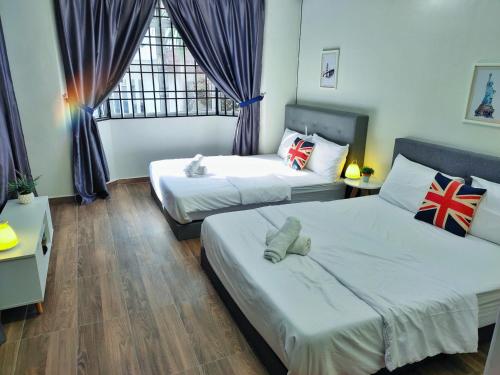 a bedroom with two beds and a window at Semi-Detached, Up to 21 Pax, 4 Bedrooms, 3 Bathrooms, 4 Car Parks by Star Home in Bayan Lepas