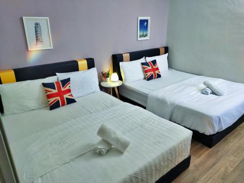 a room with two beds with british flags on them at Semi-Detached, Up to 21 Pax, 4 Bedrooms, 3 Bathrooms, 4 Car Parks by Star Home in Bayan Lepas